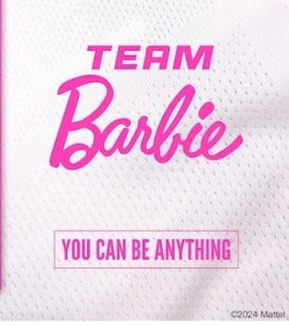 'TEAM Barbie' appears in bold pink letters on a white textured background, with 'YOU CAN BE ANYTHING' in a pink box below. ©2024 Mattel is in the lower right corner.
